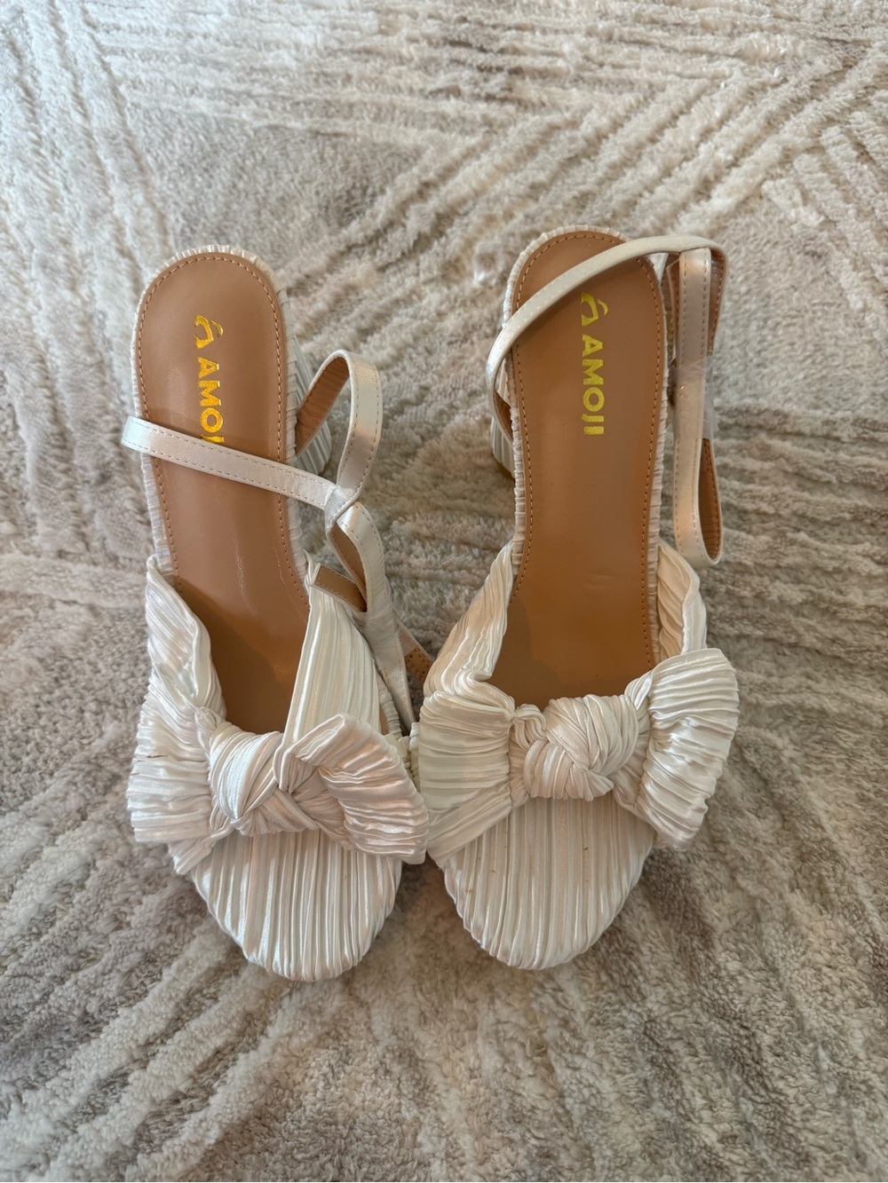 Woman’s white heels with bows